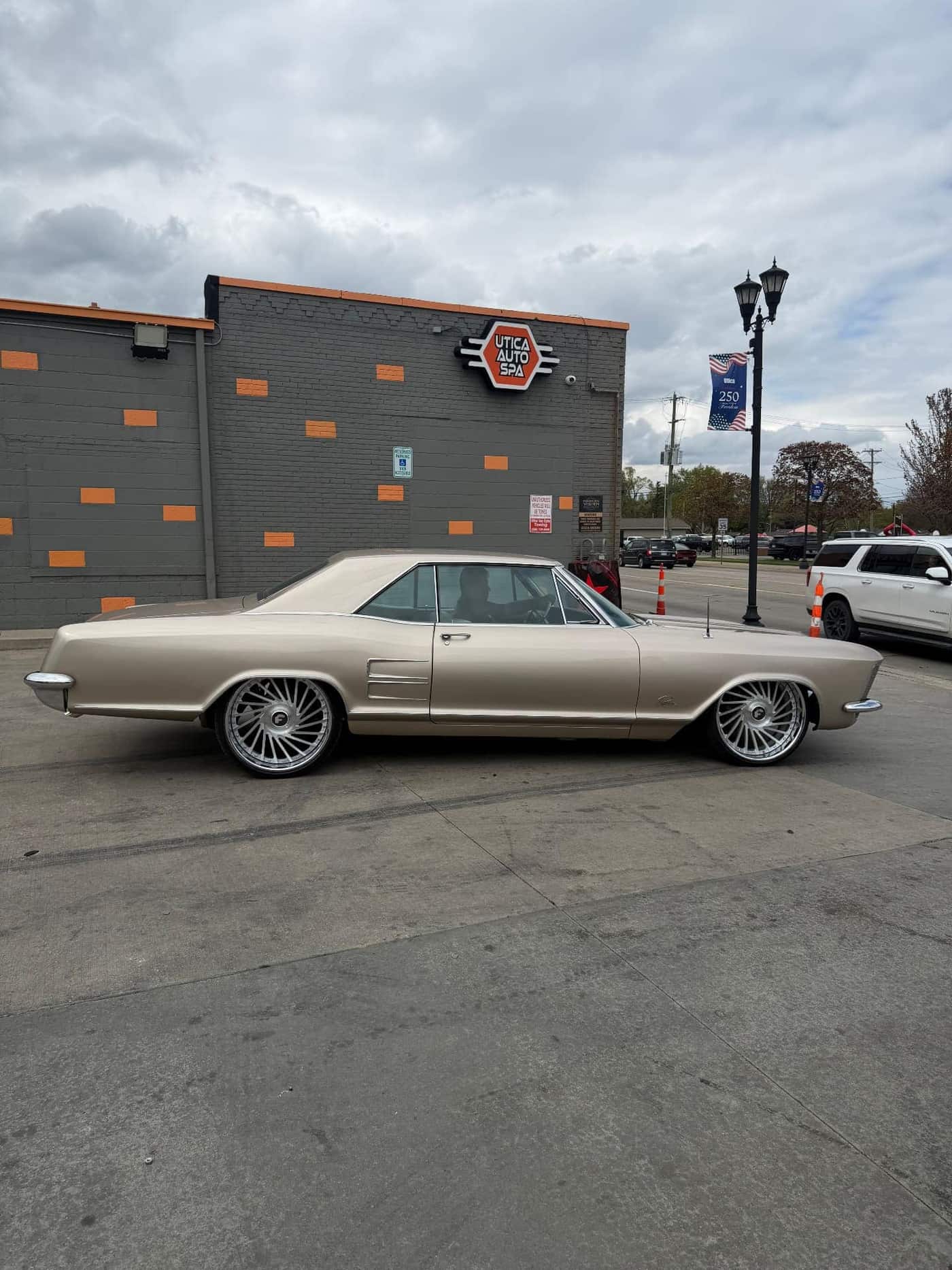 1963 Buick Riviera in champagne gold on staggered Forgiato forged wheels at Utica Auto Spa, Authorized Forgiato Dealer in Utica, Michigan