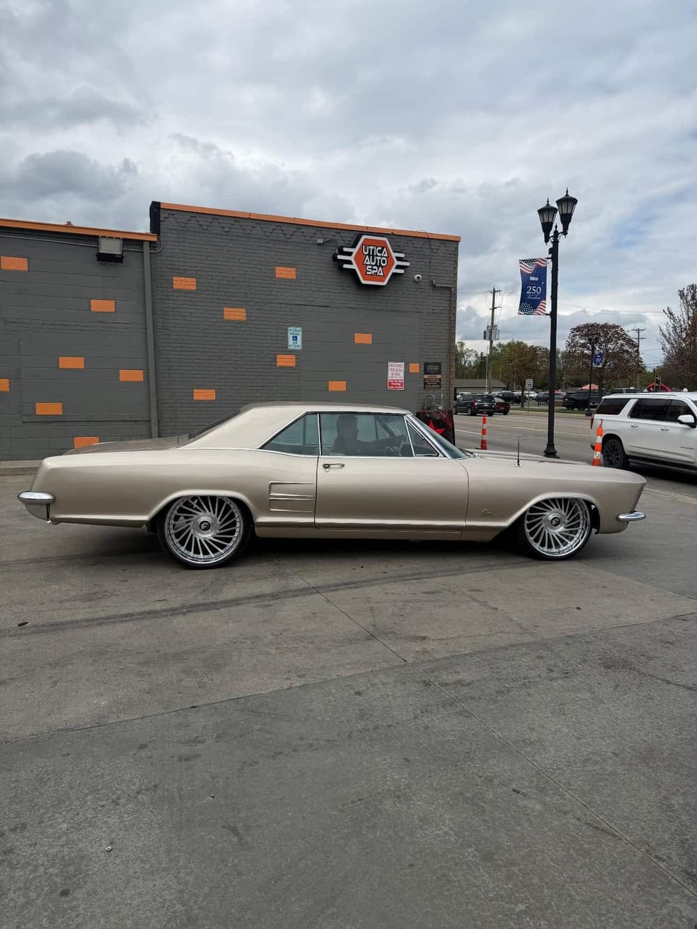 1963 Buick Riviera in champagne gold on staggered Forgiato forged wheels at Utica Auto Spa