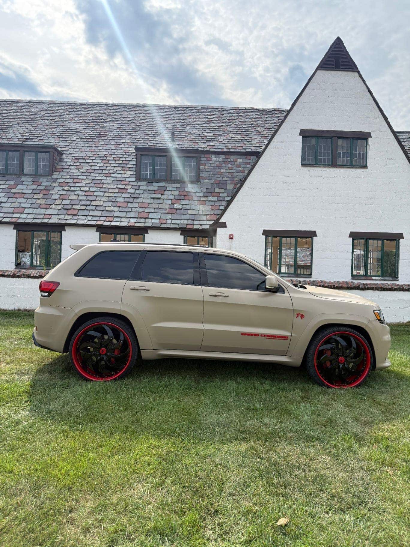 Jeep Grand Cherokee SRT in matte desert tan vinyl wrap on red-lip Forgiato wheels by Utica Auto Spa