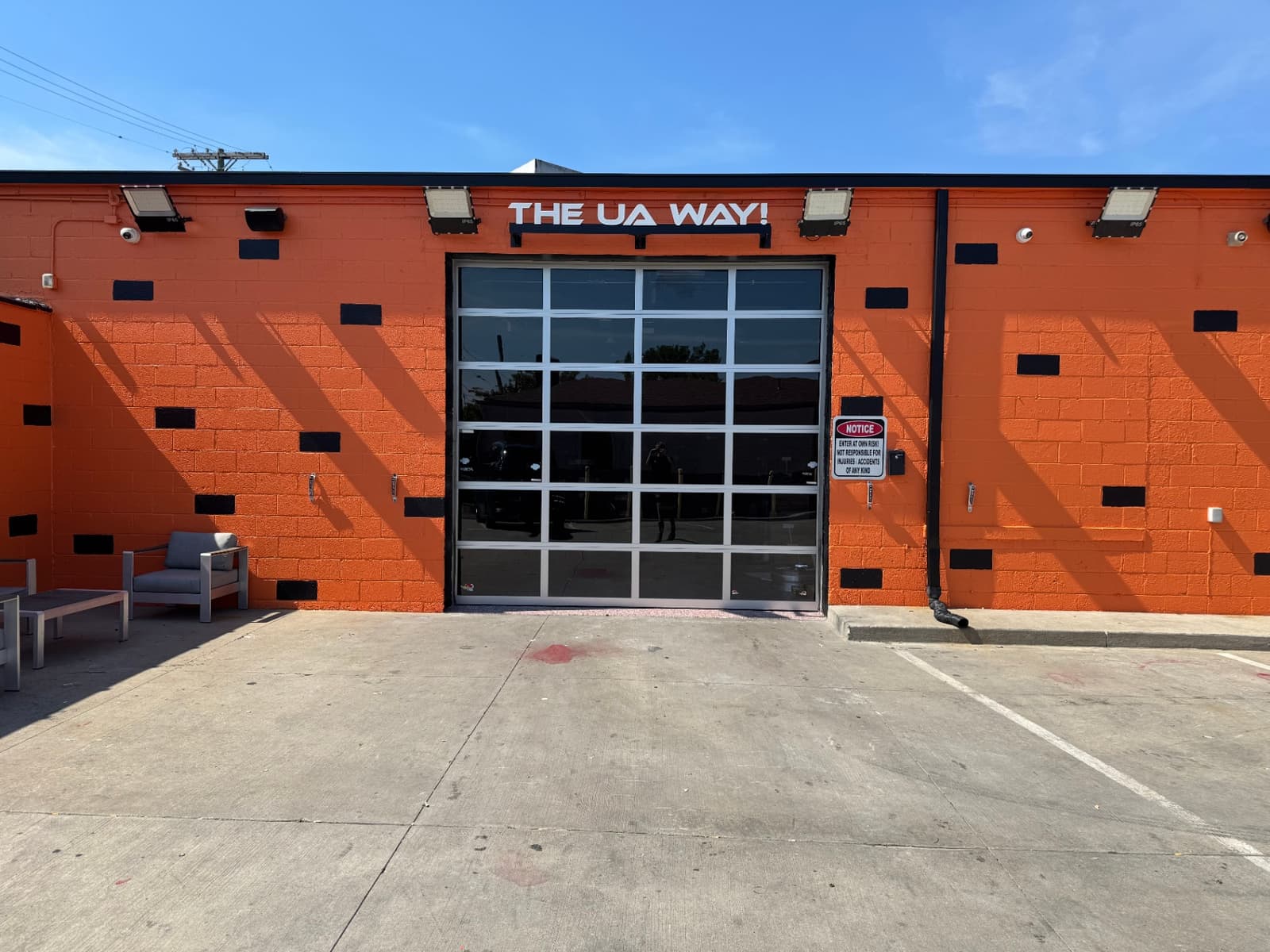 Front view of the Utica Auto Spa service bay entrance with The UA Way sign